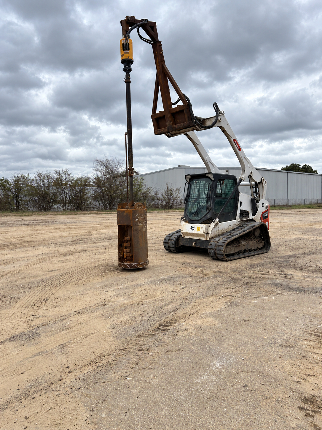 Compact equipment with a bellbottom drilling attachment at a Greater Houston jobsite